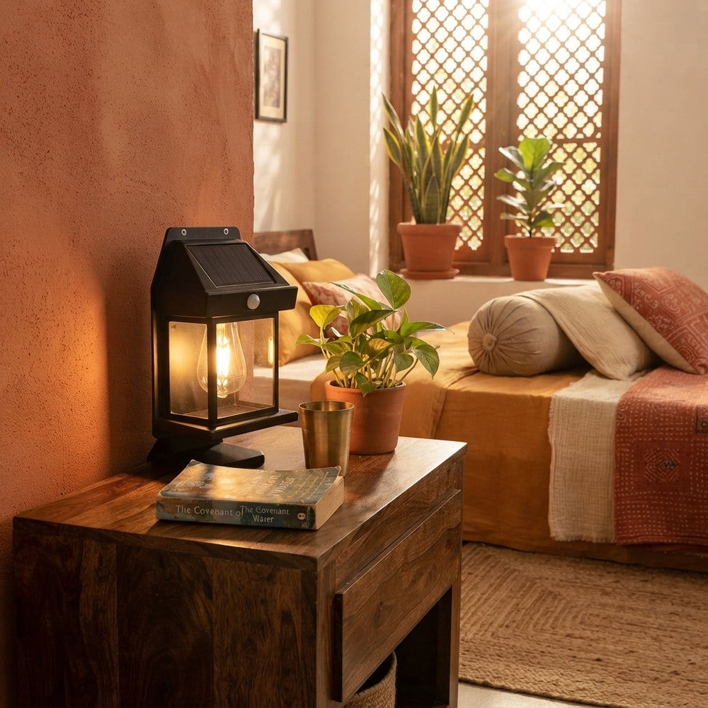 A solar wireless lamp glowing softly on a bedside table in a cozy Indian home with terracotta accents.